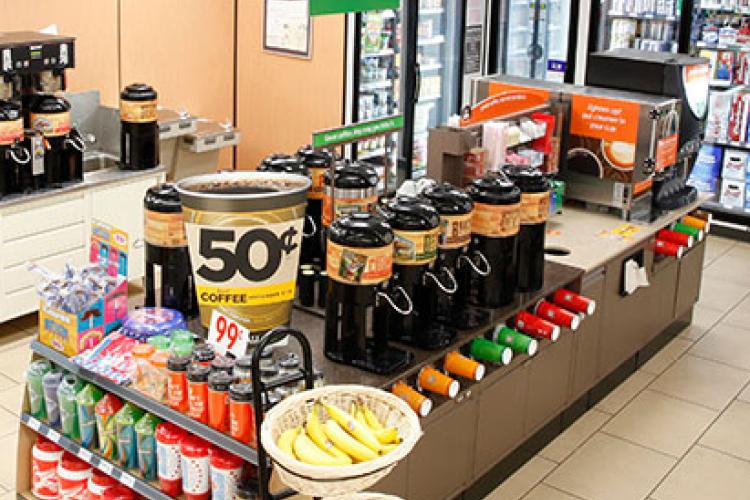 Coffee stand and bananas inside a 7 Eleven store 